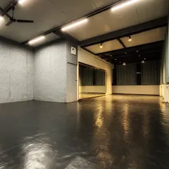 The studio in the evening, with warm lighting creating a peaceful atmosphere for our late sessions. The dark, reflective flooring and sound-dampening walls help create an immersive experience.