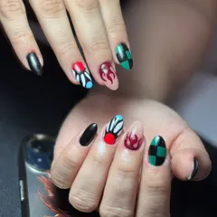 For the anime fans, I hand-painted this detailed 'Demon Slayer' inspired set. Each nail features a unique design, showcasing my precision and ability to bring any character or theme to life on your nails.