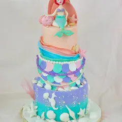 Let's go under the sea! This multi-tiered mermaid cake is a deep-sea dream, with colorful scales, seashell details, and a beautifully sculpted Ariel on top.