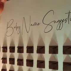 An interactive 'Baby Name Suggestions' wall is a wonderful way to engage guests. We designed this elegant display with custom calligraphy to fit the baby shower's sophisticated theme.