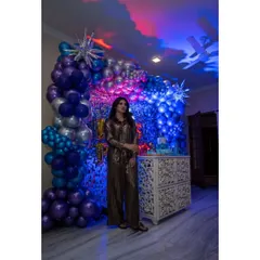 A full view of the party decor we designed for Urvashi Rautela. The setup included a floor-to-ceiling balloon arrangement in metallic blues and purples against a silver shimmer wall, creating a dramatic and stylish look.