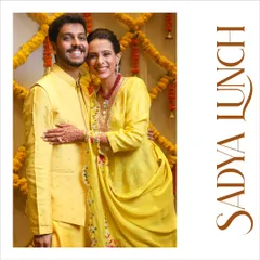A portrait from the 'Sadya Lunch' event in Kochi. The couple, dressed in vibrant yellow, perfectly complements the festive and traditional theme of the South Indian feast.
