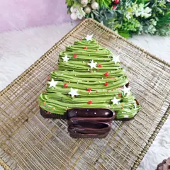 This brownie Christmas tree is a chocolate lover's dream. A rich brownie is frosted with green icing and decorated with star sprinkles for a festive touch.