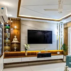 This living room design combines a marble-finish wall panel with rich wood tones. The false ceiling with recessed lighting adds a layer of sophistication.