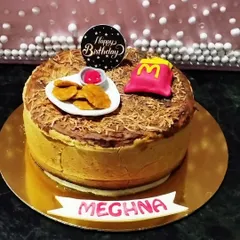 Concept cakes are so much fun to make. This one was for a McDonald's fan, complete with fondant nuggets and fries on a rich cheesecake. It's all about celebrating what makes someone happy.