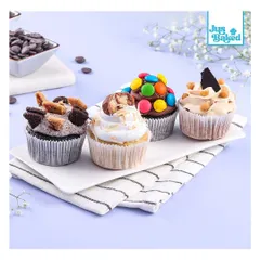 Another one of our delicious cupcake assortments. This box features a variety of toppings like M&Ms, Oreo cookies, and Snickers, making it a fun and tasty treat for any occasion.