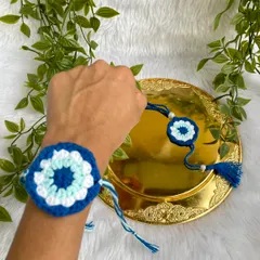 Showing the Rakhi tied on a wrist to demonstrate how it looks when worn.