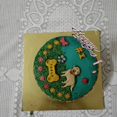 A close-up of the custom birthday cake I made for Pablo. I design every cake to be completely dog-safe and decorate it with fun themes, like this garden design with a little bone that has his name on it. It’s the centerpiece of the celebration.