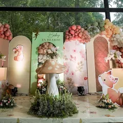The main stage for the "Baby in Bloom" shower featured a whimsical woodland scene. We used cutouts of adorable forest creatures, oversized mushrooms, and beautiful cherry blossom arrangements against a backdrop of pastel-colored panels.
