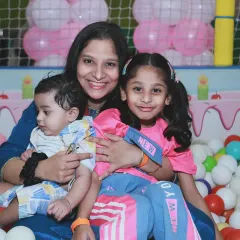 A beautiful family portrait of a mother with her two children in a colorful ball pit. Even in a playful setting, we can capture a moment of connection and love.