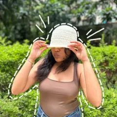 A fun, playful shot of our crochet bucket hat. The brim provides just the right amount of shade while looking cute.