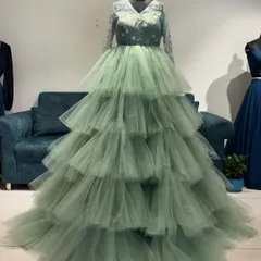 Who says you can't have drama? This pastel green reception gown is all about making an entrance. I designed it with endless layers of tulle and delicate embroidery on the bodice for a look that's both dreamy and a total power move.