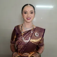 A full view of the radiant look for her post-wedding pujani ceremony. The makeup is designed to look fresh and timeless, ensuring she looks perfect both in person and in photographs.