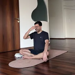 Pranayama is the practice of regulating the breath to guide our energy. Here, a student practices Nadi Shodhana (Alternate Nostril Breathing) to find balance and calm.