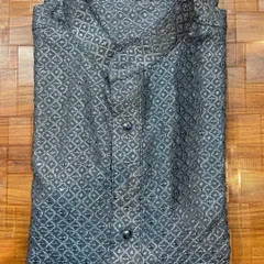 This is a custom-made grey kurta featuring an intricate self-pattern and subtle sequin detailing. It's an understated yet elegant option for evening events or family functions.