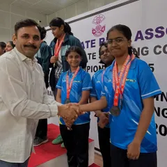 Presenting a medal to one of our promising young shooters on the podium. Seeing their hard work pay off is the greatest reward for a coach.