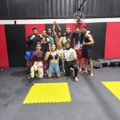 Another shot of the team celebrating our new champion. This moment captures the spirit of Ace MMA, where every individual's success is a victory for the entire team.