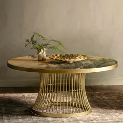 Art doesn't have to hang on a wall. This center table features an exquisite landscape design printed directly onto its glass surface, merging modern luxury with timeless artistry to create a sophisticated focal point.