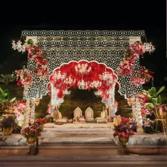 A modern take on Rajasthani royalty. This mandap uses intricate black and white patterns as a backdrop for a dramatic arch of red florals, blending traditional motifs with a bold, contemporary design sensibility.