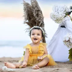 There's something magical about a baby's laughter by the sea. For this beach milestone session, we used the golden hour light and a simple, breezy setup to capture this little one's radiant smile.