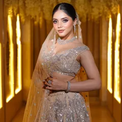 A modern reception look. This bride is glowing in a beautiful silver-beige lehenga, with soft glam makeup and diamond jewelry.