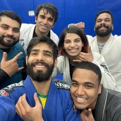 Posing after a tough rolling session. The Gi adds a layer of friction and strategy to every spar.