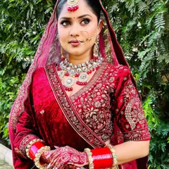 A full portrait of a bride in her magnificent maroon velvet lehenga. My styling ensures the heavy outfit is draped for both beauty and comfort, allowing her to move with grace.