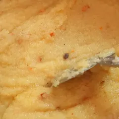 A close up of fluffy Rava Kesari, a sweet semolina dish that is a must have in any South Indian festive meal. I make it rich with ghee and garnish it with nuts.