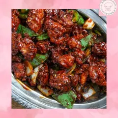 A close-up of our spicy and tangy Chilli Chicken, a must-have from our Indo-Chinese menu. Each piece is coated in a flavourful sauce with fresh capsicum and onions, making it a perfect starter for parties.