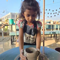 A close-up of the creative process. With a little guidance and a lot of imagination, a simple lump of clay transforms into a beautiful pot. It's amazing to watch their confidence grow as their pot does.