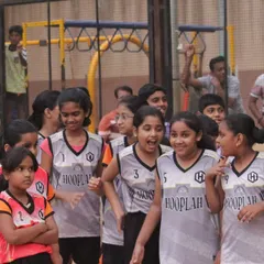 Young players from the girls' division sharing a smile during the tournament. It's a playground for everyone to grow and shine.