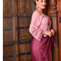 This pose from the same apparel shoot offers a different angle of the outfit, providing more visual information for the customer while maintaining the warm, rustic aesthetic.