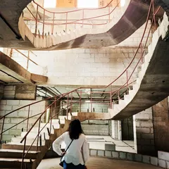 The structural form of a multi-level spiral staircase during construction. This image shows the complex architectural work we undertake, creating dramatic and functional centerpieces for custom homes from the ground up.