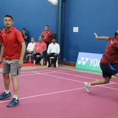 An intense moment in a doubles match, showcasing the high level of competition in the veteran and masters tournaments we manage.