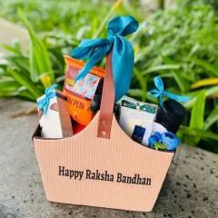 A stylish Raksha Bandhan hamper for a "Bhaiya & Bhabhi" in a modern tote bag. The bright blue satin ribbon adds a pop of color to this festive gift.