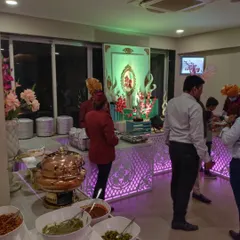Guests enjoying the food at an indoor event. Our buffet counters are designed to be both beautiful and functional, allowing for easy movement and service.