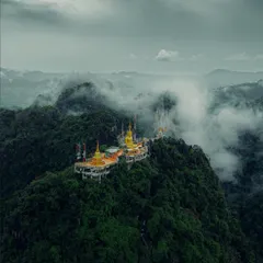 A moody, atmospheric shot of a temple perched on a misty mountain in Krabi. Thailand's spiritual side is just as captivating as its beaches.