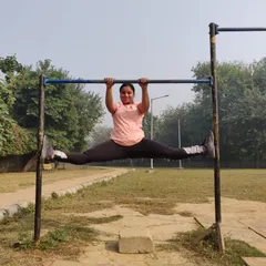 A middle split performed while hanging from a pull-up bar. This is an advanced calisthenics move that challenges your grip strength, core stability, and hip flexibility all at once.