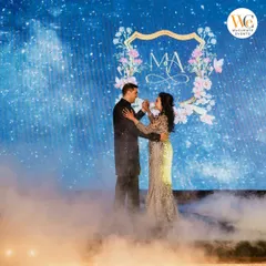 We bring your unique vision to life with thematic decor. For this celestial-themed Sangeet, the couple shared their first dance amidst swirling fog and a starry backdrop, creating a moment that felt like it was straight out of a fairytale.