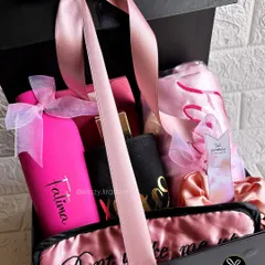 A hug in a box, custom-made for her. This black and pink themed hamper features a personalized bottle, a satin robe, and a 'Don't wake me up' sleep mask.