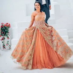 A full-length view of the Shantanu & Nikhil designer gown, showcasing its beautiful fall and intricate lacework. This is an ideal choice for a reception or engagement party.