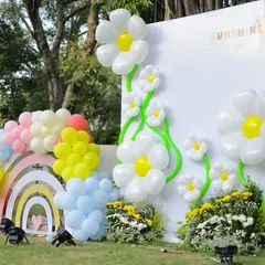 Another angle of the sunshine and daisy backdrop, showing how the balloon art and custom structures come together to create a cheerful and impressive focal point for an outdoor party.