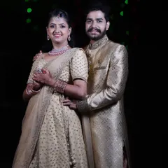 The happy couple at their reception. The bride's makeup is elegant and timeless, designed to look beautiful both in person and in photographs.