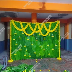 A traditional Simmanta decoration featuring a backdrop made of fresh banana leaves and marigold flower garlands.