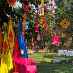 A closer look at the seating area for the Mehandi. The bright pink sofa and colorful decor elements create a perfect photo opportunity and a comfortable spot for the bride.
