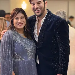 A candid shot of actor Paras Chhabra looking happy and confident in a custom navy blue velvet blazer with all-over silver stud embellishments.