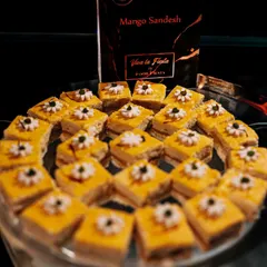 Keep calm and eat Sandesh. A platter of delicate Mango Sandesh, beautifully arranged and garnished. This classic Bengali sweet is a light and elegant option for any dessert spread.