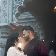 A close up shot showcasing the detailed carving on the pillars of the Indian set. The soft backlighting creates an intimate and glowing effect, ideal for romantic couple portraits.
