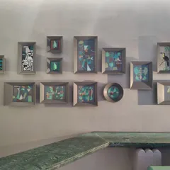 A collection of small, framed canvas paintings created for a commercial space. The series explores abstract forms and figures in a consistent color palette, designed to be viewed as a collective story.