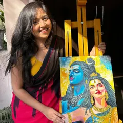 Feeling blessed and happy next to my completed Shiv Parvati painting on its easel. The sunlight really brings out the vibrant colors.